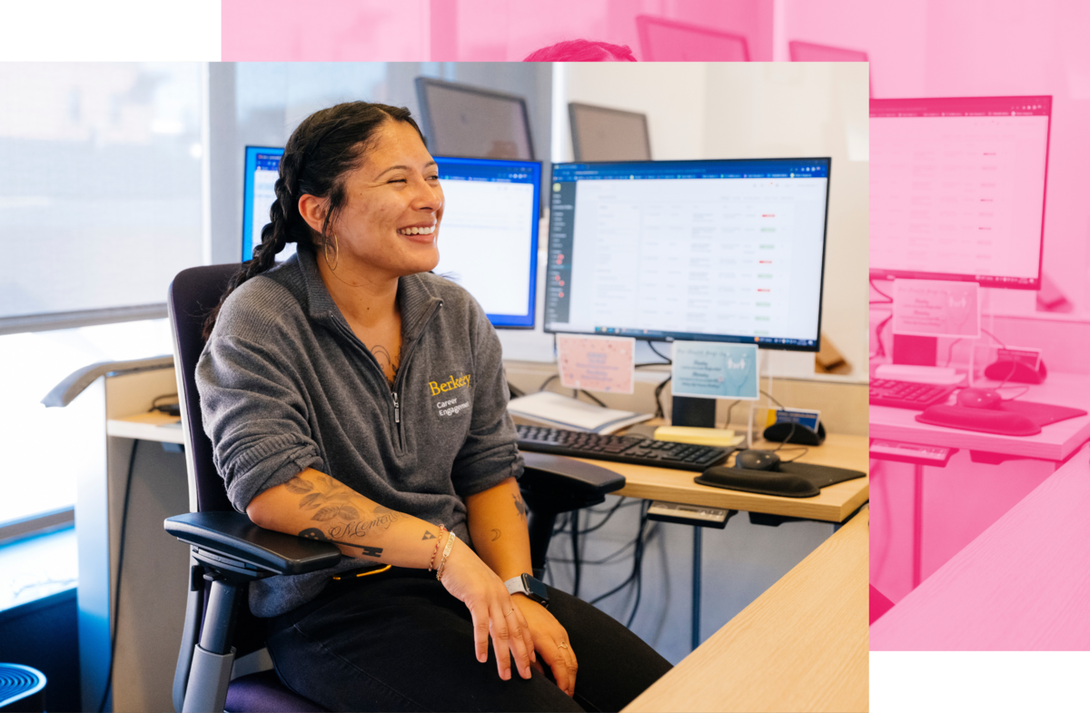 A Career Engagement Center employee smiling behind their desk