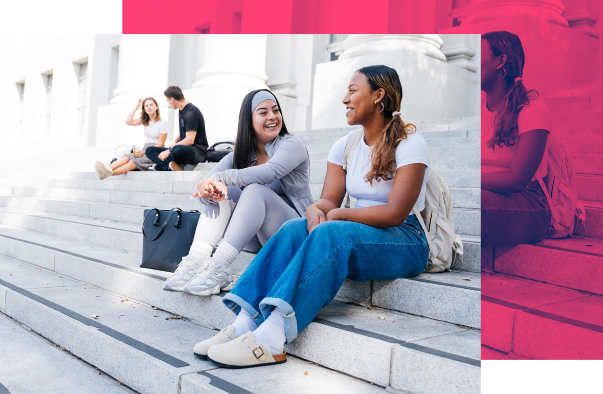 Photo of two students sitting in front of Sproul Hall with pink color block design in background