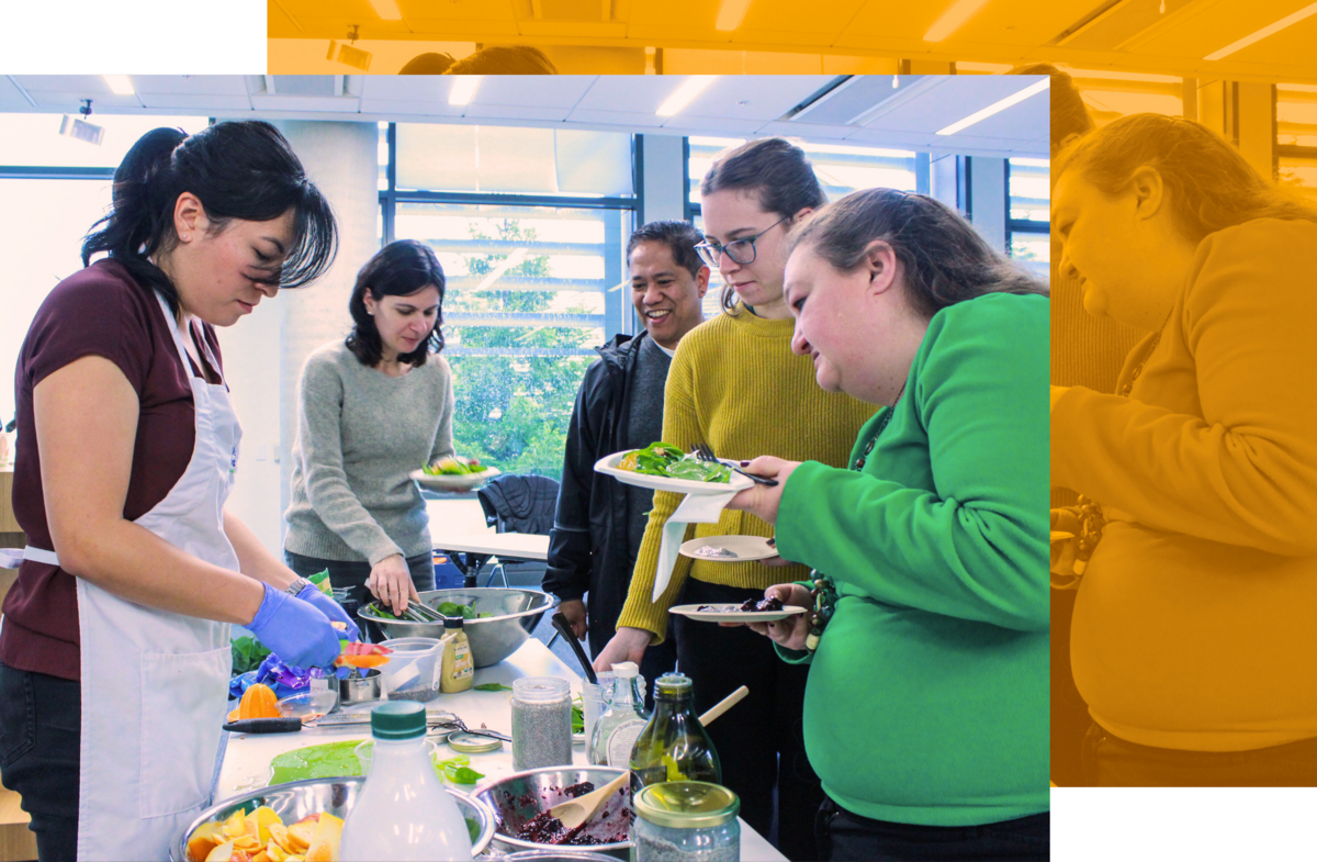 A group of people watching a food prep demonstration