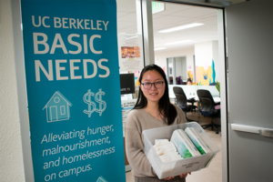 Student Jessica Wang of the Coalition for the Institutionalization of Free Menstrual Product  at UC Berkeley poses with a box of menstrual pads