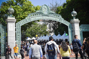People Walking By Booths at Cal Day