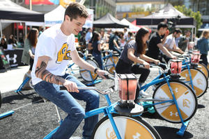UC Berkeley students pedal their smoothie bikes at the UA-Cal Giveback Challenge event
